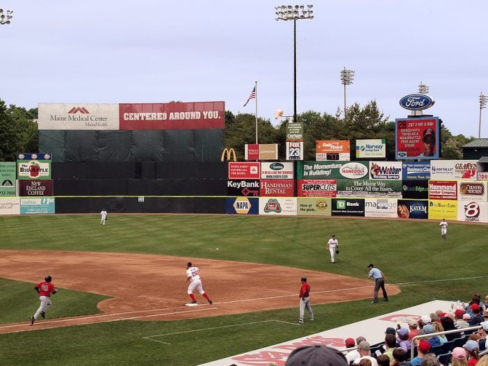 Outfield Advertising at a Minor League Baseball Game